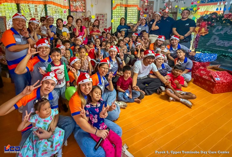 LCD staff together with children taking a Christmas party pic.